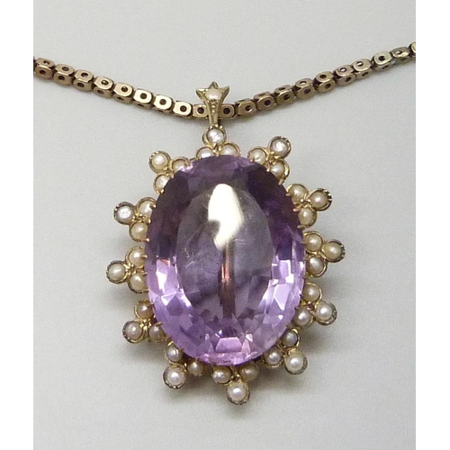 7014 - A yellow metal amethyst set pendant with a seed pearl border, on a 9ct gold chain, 15g total, pendan... 