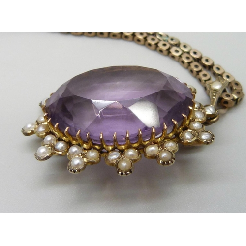 7014 - A yellow metal amethyst set pendant with a seed pearl border, on a 9ct gold chain, 15g total, pendan... 