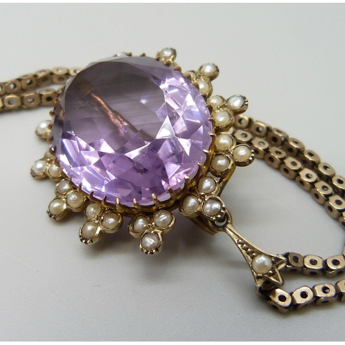 7014 - A yellow metal amethyst set pendant with a seed pearl border, on a 9ct gold chain, 15g total, pendan... 