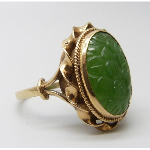 7015 - A 9ct gold oval carved jade ring, London 1960, stone 1.7 x 1.3cm, 7.5g, U