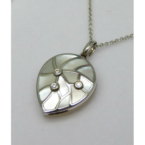 7021 - An 18ct white gold diamond and mother of pearl pendant on an 18ct white gold 18 inch chain, 0.03ct, ... 