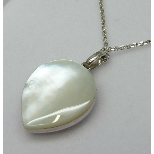 7021 - An 18ct white gold diamond and mother of pearl pendant on an 18ct white gold 18 inch chain, 0.03ct, ... 