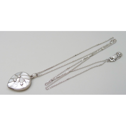 7021 - An 18ct white gold diamond and mother of pearl pendant on an 18ct white gold 18 inch chain, 0.03ct, ... 