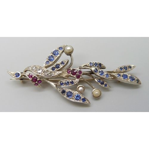 7026 - A white metal brooch with yellow metal finish verso, set with diamonds, sapphires, rubies and pearls... 