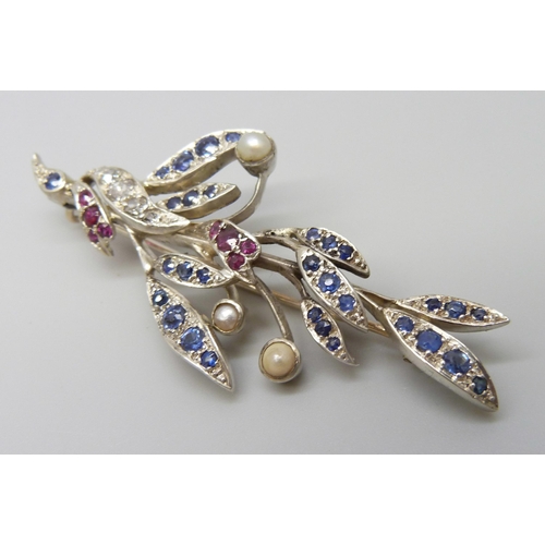 7026 - A white metal brooch with yellow metal finish verso, set with diamonds, sapphires, rubies and pearls... 