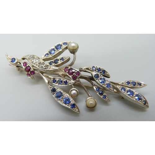 7026 - A white metal brooch with yellow metal finish verso, set with diamonds, sapphires, rubies and pearls... 