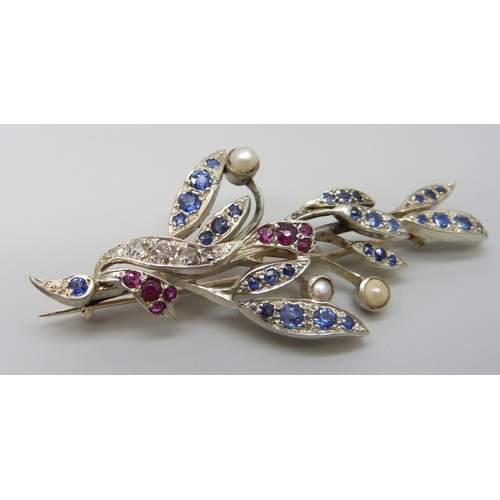 7026 - A white metal brooch with yellow metal finish verso, set with diamonds, sapphires, rubies and pearls... 