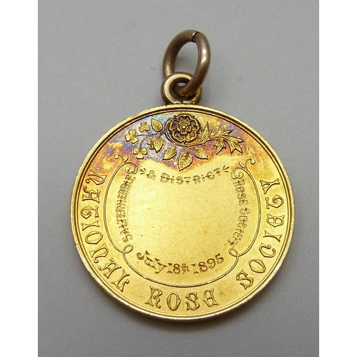 7044 - A late Victorian yellow metal National Rose Society medallion, Salterhebble 1895, cased, 9.7g