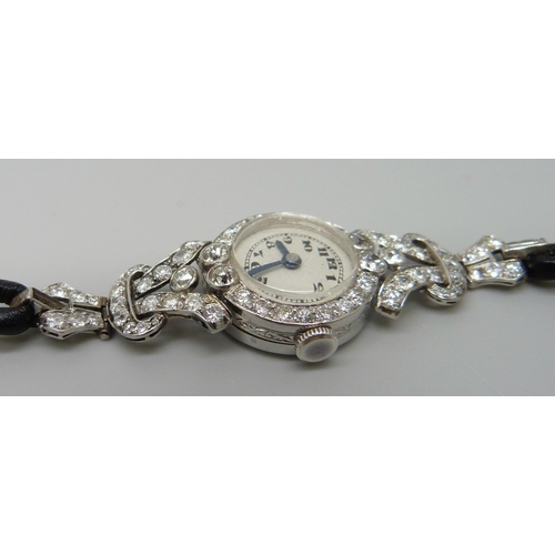 7050 - A lady's platinum and diamond set cocktail wristwatch, 19mm case including crown, one baguette cut d... 