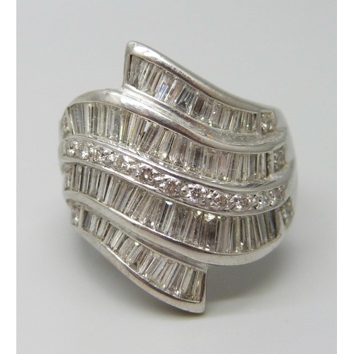 7053 - A large white metal ring set with approximately 4cts of baguette cut diamonds, 2.5cm, 22.4g, V/W