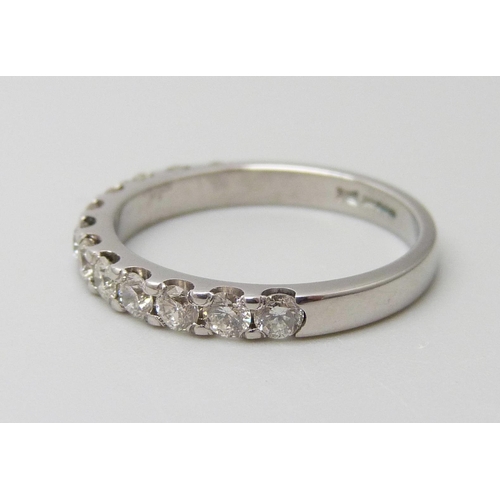 7056 - An 18ct white gold half eternity ring set with 0.75ct of G SI diamonds, 3g, M