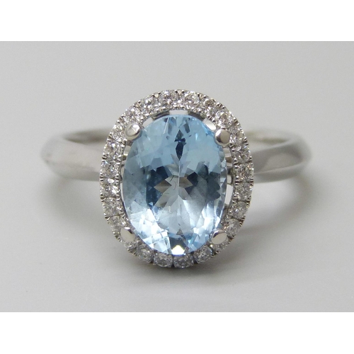 7059 - A platinum and 1.5ct oval aquamarine ring set with a round cut diamond border, 0.20ct G VS, 5.9g, M.... 