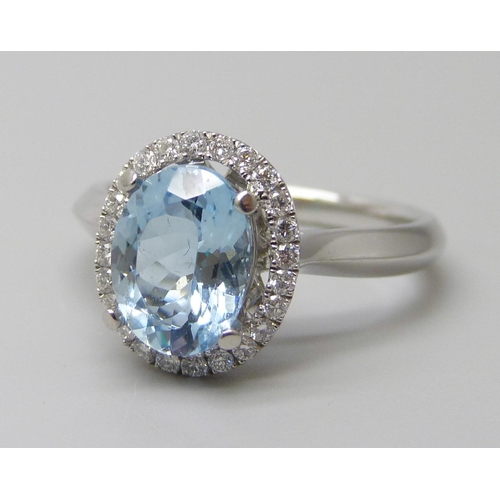 7059 - A platinum and 1.5ct oval aquamarine ring set with a round cut diamond border, 0.20ct G VS, 5.9g, M.... 