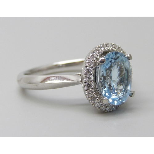 7059 - A platinum and 1.5ct oval aquamarine ring set with a round cut diamond border, 0.20ct G VS, 5.9g, M.... 