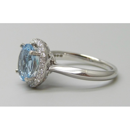 7059 - A platinum and 1.5ct oval aquamarine ring set with a round cut diamond border, 0.20ct G VS, 5.9g, M.... 