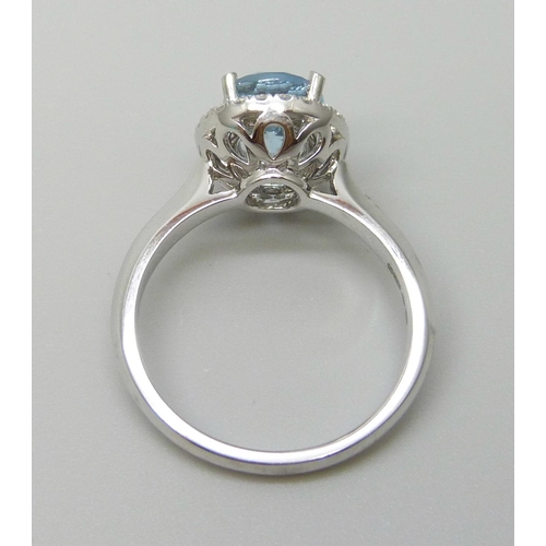 7059 - A platinum and 1.5ct oval aquamarine ring set with a round cut diamond border, 0.20ct G VS, 5.9g, M.... 