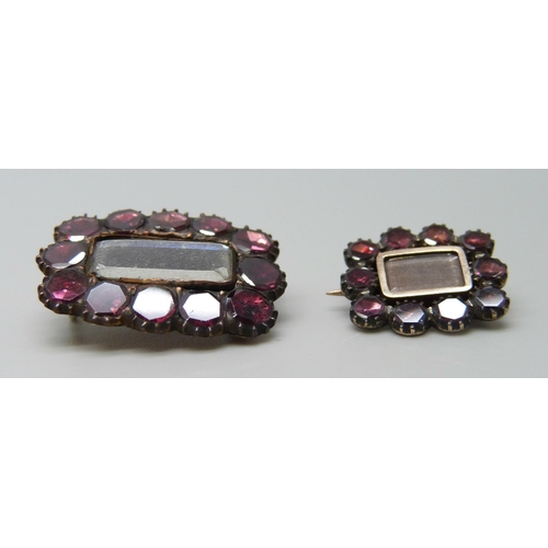 7060 - Two 19th Century yellow metal mourning brooches set with garnets, 3.9g, 2.4 x 1.8cm and 1.8g, 1.6 x ... 