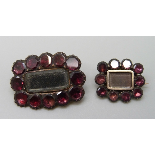 7060 - Two 19th Century yellow metal mourning brooches set with garnets, 3.9g, 2.4 x 1.8cm and 1.8g, 1.6 x ... 