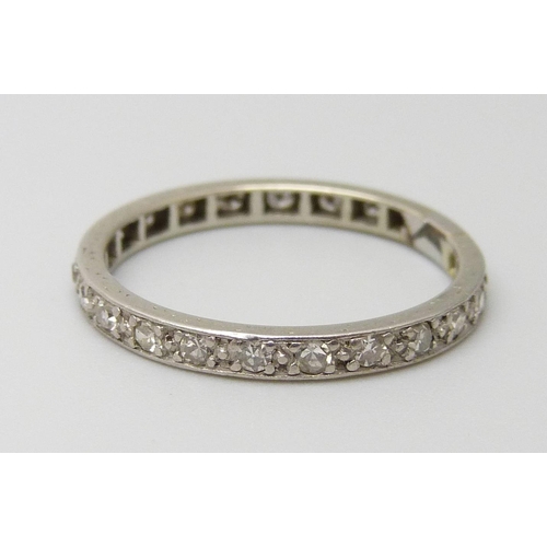 7062 - A white metal set diamond eternity ring, 2g, O