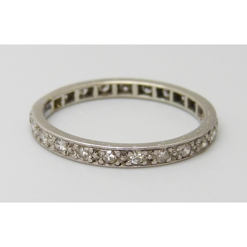 7062 - A white metal set diamond eternity ring, 2g, O