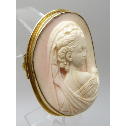 7064 - A yellow metal framed angel skin cameo brooch depicting a lady in a veil, tests as 14ct gold with a ... 