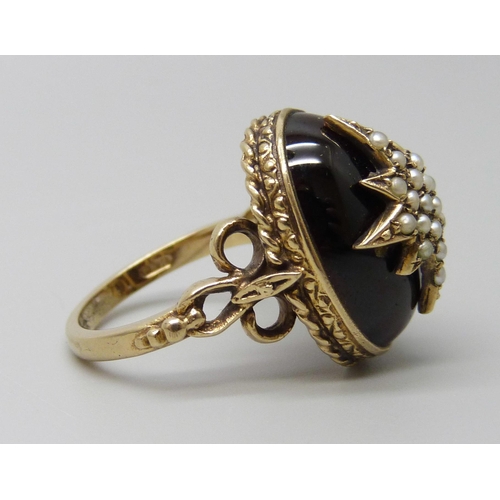 7068 - A Victorian style 9ct gold ring with seed pearl set starburst detail on a cabochon garnet, London 19... 