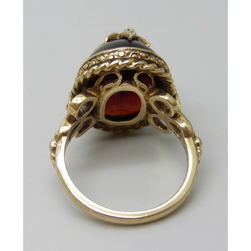 7068 - A Victorian style 9ct gold ring with seed pearl set starburst detail on a cabochon garnet, London 19... 