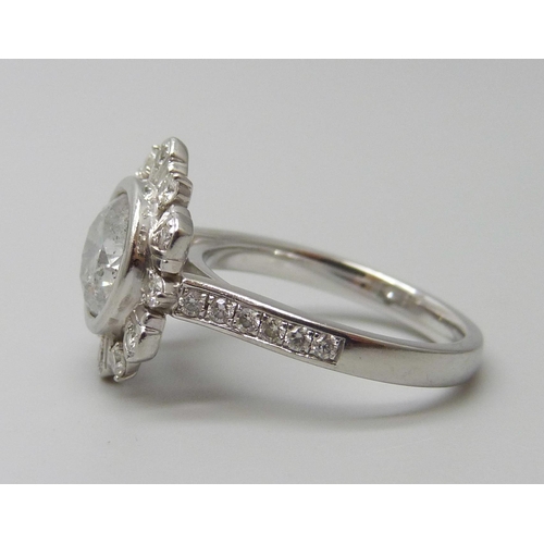 7070 - A platinum and diamond ring set with a 2.24ct round brilliant cut central diamond and diamond set su... 