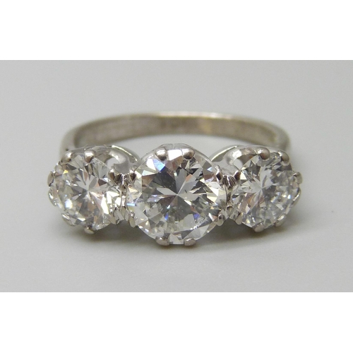 7074 - An 18ct white gold three stone diamond ring, central diamond approximately 1ct, total diamond weight... 