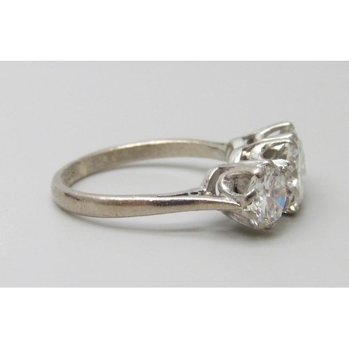 7074 - An 18ct white gold three stone diamond ring, central diamond approximately 1ct, total diamond weight... 