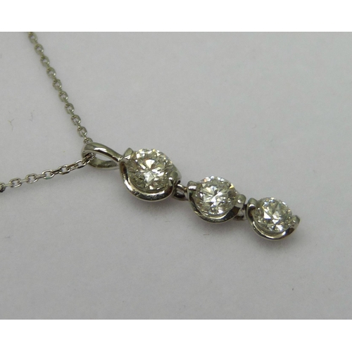 7075 - A platinum and diamond three stone pendant with adjustable length chain, 0.6ct total diamond weight ... 