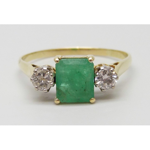 7078 - A yellow metal, emerald and diamond three stone ring, emerald measures 7.3mm x 6.3mm, diamond weight... 