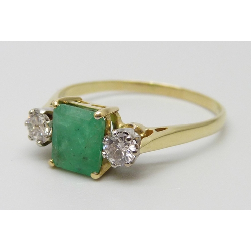 7078 - A yellow metal, emerald and diamond three stone ring, emerald measures 7.3mm x 6.3mm, diamond weight... 