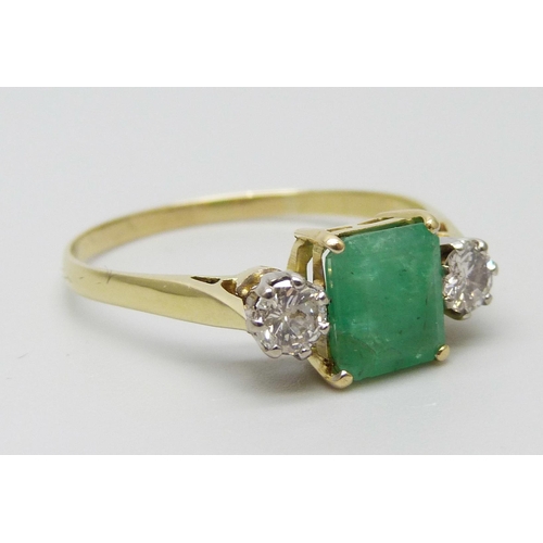 7078 - A yellow metal, emerald and diamond three stone ring, emerald measures 7.3mm x 6.3mm, diamond weight... 