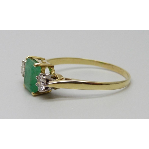 7078 - A yellow metal, emerald and diamond three stone ring, emerald measures 7.3mm x 6.3mm, diamond weight... 