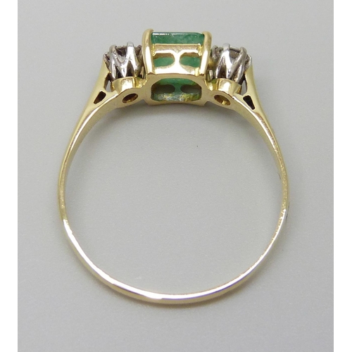 7078 - A yellow metal, emerald and diamond three stone ring, emerald measures 7.3mm x 6.3mm, diamond weight... 