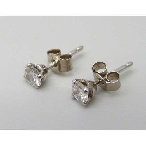 7082 - A pair of hallmarked 18ct white gold diamond stud earrings, total diamond weight 0.45ct