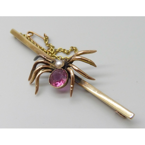 7086 - A 9ct gold spider bar brooch set with a seed pearl and pink stone, 4.9g, 6.4cm