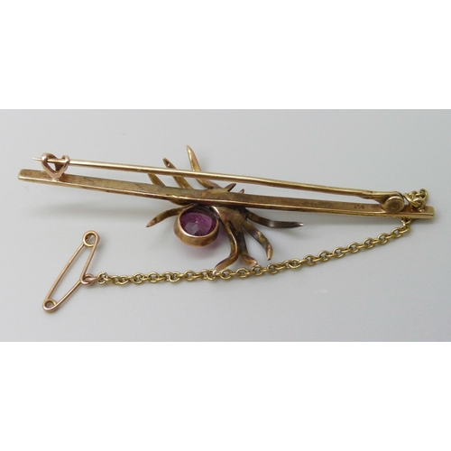 7086 - A 9ct gold spider bar brooch set with a seed pearl and pink stone, 4.9g, 6.4cm