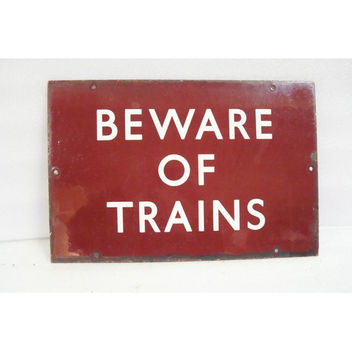 9033 - A BR(M) flangeless enamel railway sign inscribed BEWARE OF TRAINS. Measures 30.5 x 46cm HxW. To be s... 