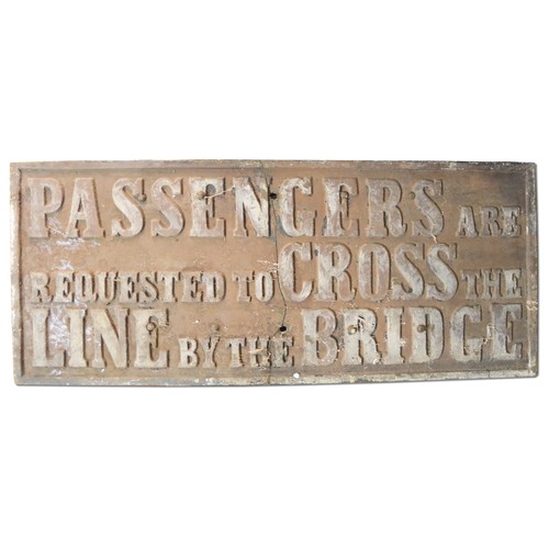 9046 - A large cast iron railway sign PASSENGERS ARE REQUESTED TO CROSS THE LINE BY THE BRIDGE. The sign ha... 