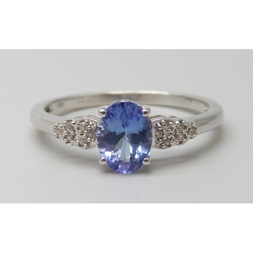 7097 - A 9ct white gold tanzanite and white stone ring, hallmarked and also stamped 10k, 2.7g, U