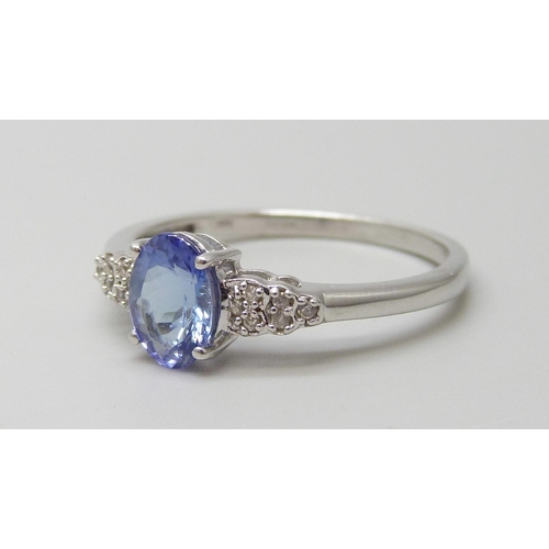 7097 - A 9ct white gold tanzanite and white stone ring, hallmarked and also stamped 10k, 2.7g, U