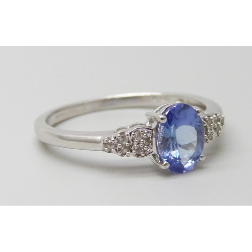 7097 - A 9ct white gold tanzanite and white stone ring, hallmarked and also stamped 10k, 2.7g, U