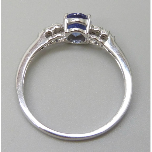 7097 - A 9ct white gold tanzanite and white stone ring, hallmarked and also stamped 10k, 2.7g, U