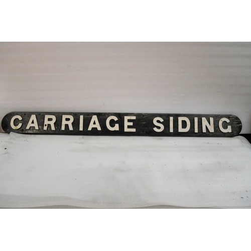 9063 - A wooden sign with cast iron letters CARRIAGE SIDING. Measures 16 x 162cm HxW. To be sold with no re... 