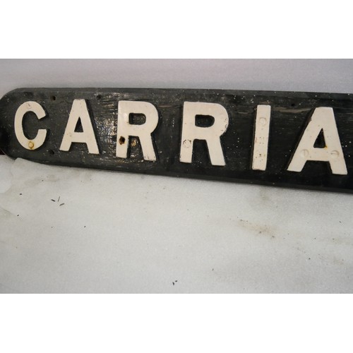 9063 - A wooden sign with cast iron letters CARRIAGE SIDING. Measures 16 x 162cm HxW. To be sold with no re... 