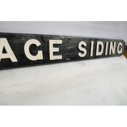 9063 - A wooden sign with cast iron letters CARRIAGE SIDING. Measures 16 x 162cm HxW. To be sold with no re... 