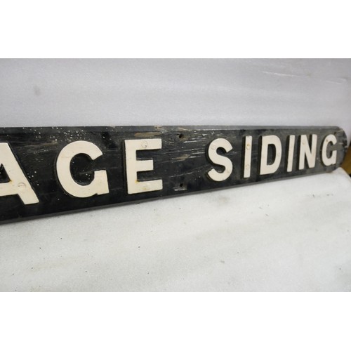 9063 - A wooden sign with cast iron letters CARRIAGE SIDING. Measures 16 x 162cm HxW. To be sold with no re... 