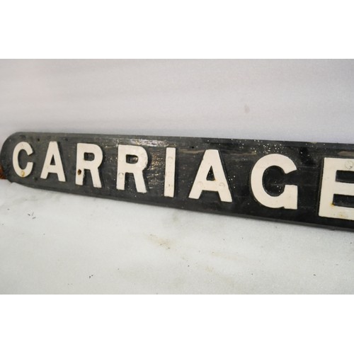 9063 - A wooden sign with cast iron letters CARRIAGE SIDING. Measures 16 x 162cm HxW. To be sold with no re... 